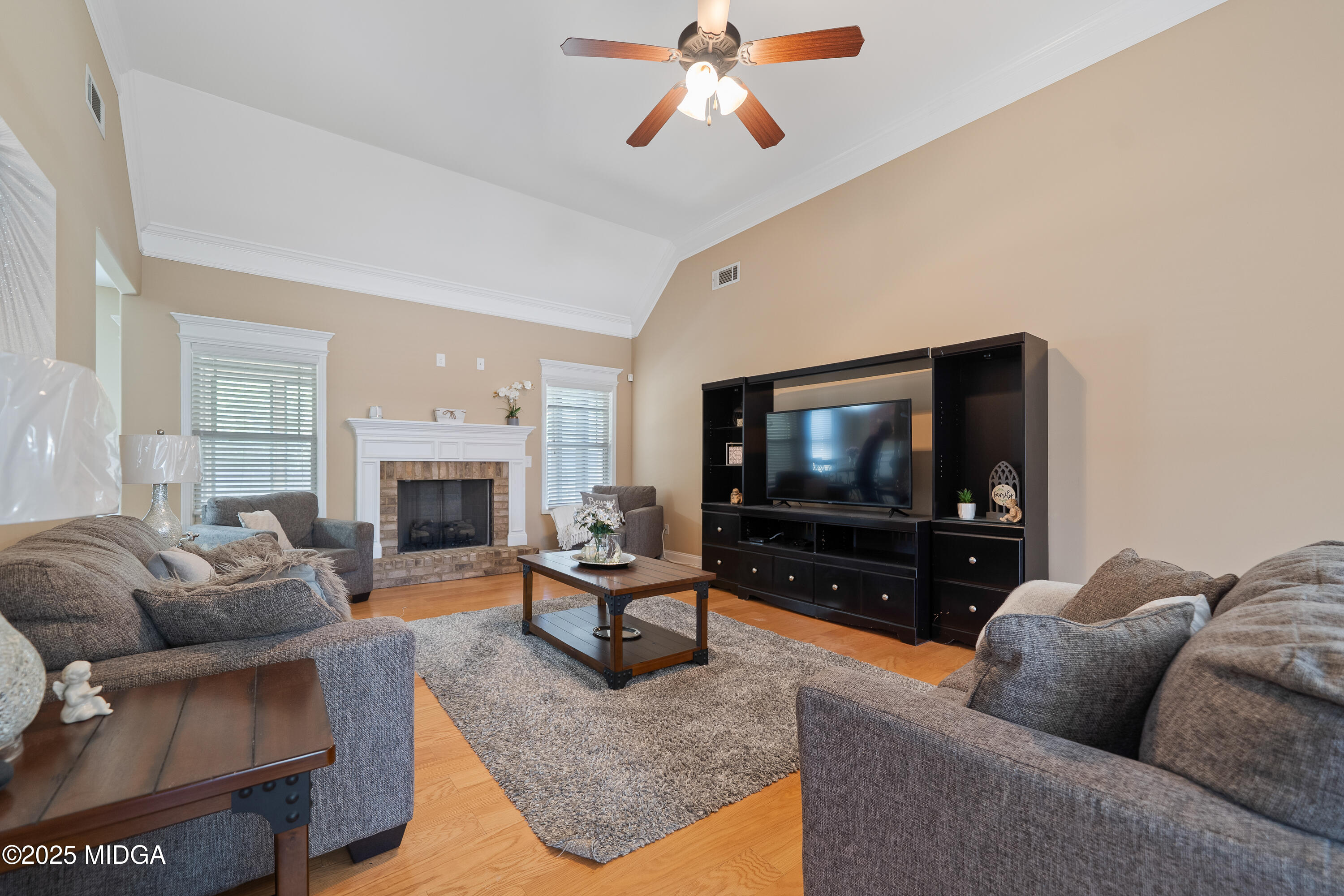 405 Stonecrest Court Macon, GA 31216 - Photo 11 of 45 a living room with furniture and a flat screen tv
