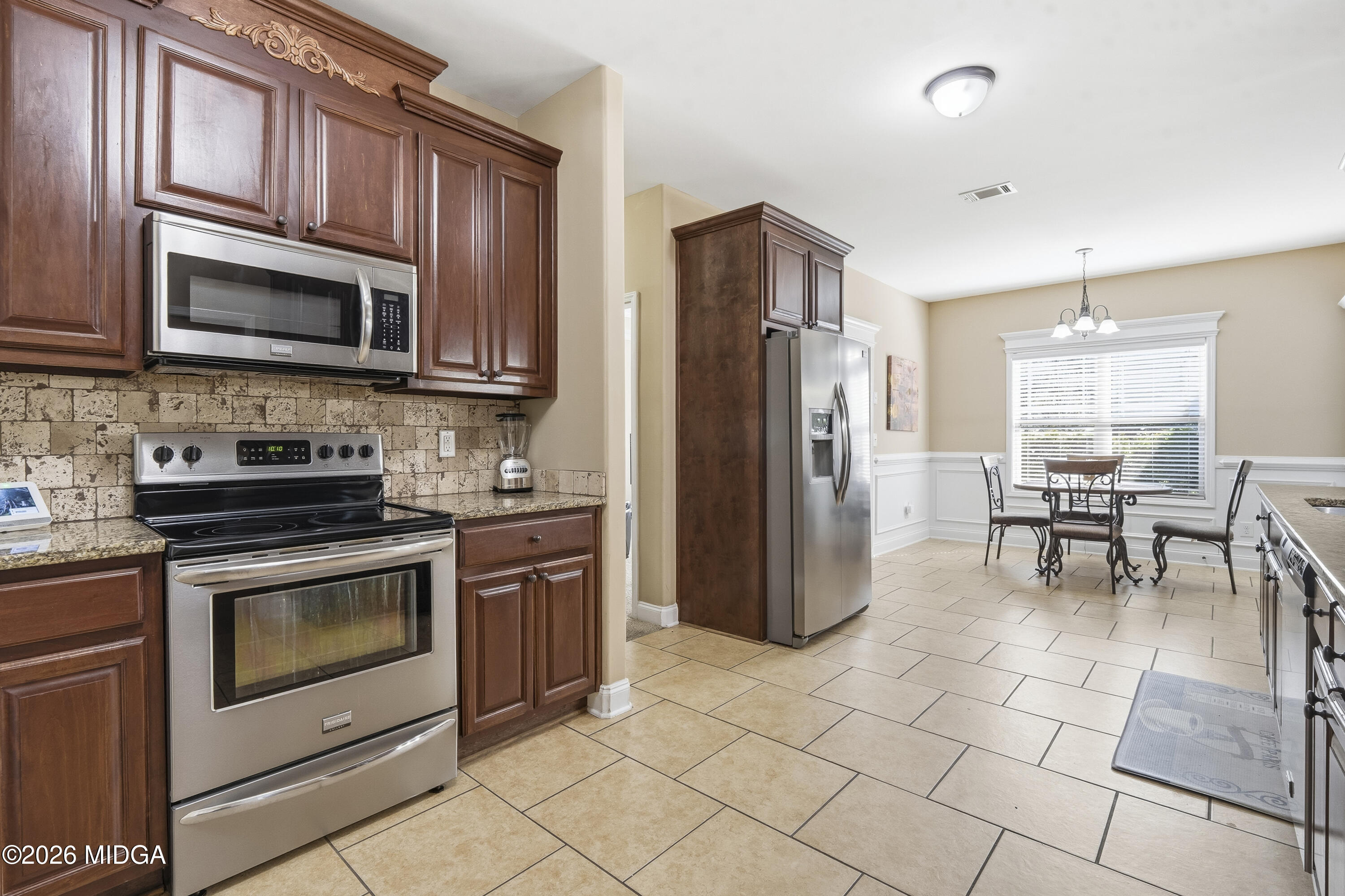 405 Stonecrest Court Macon, GA 31216 - Photo 14 of 45 a kitchen with stainless steel appliances granite countertop a stove a refrigerator and a microwave