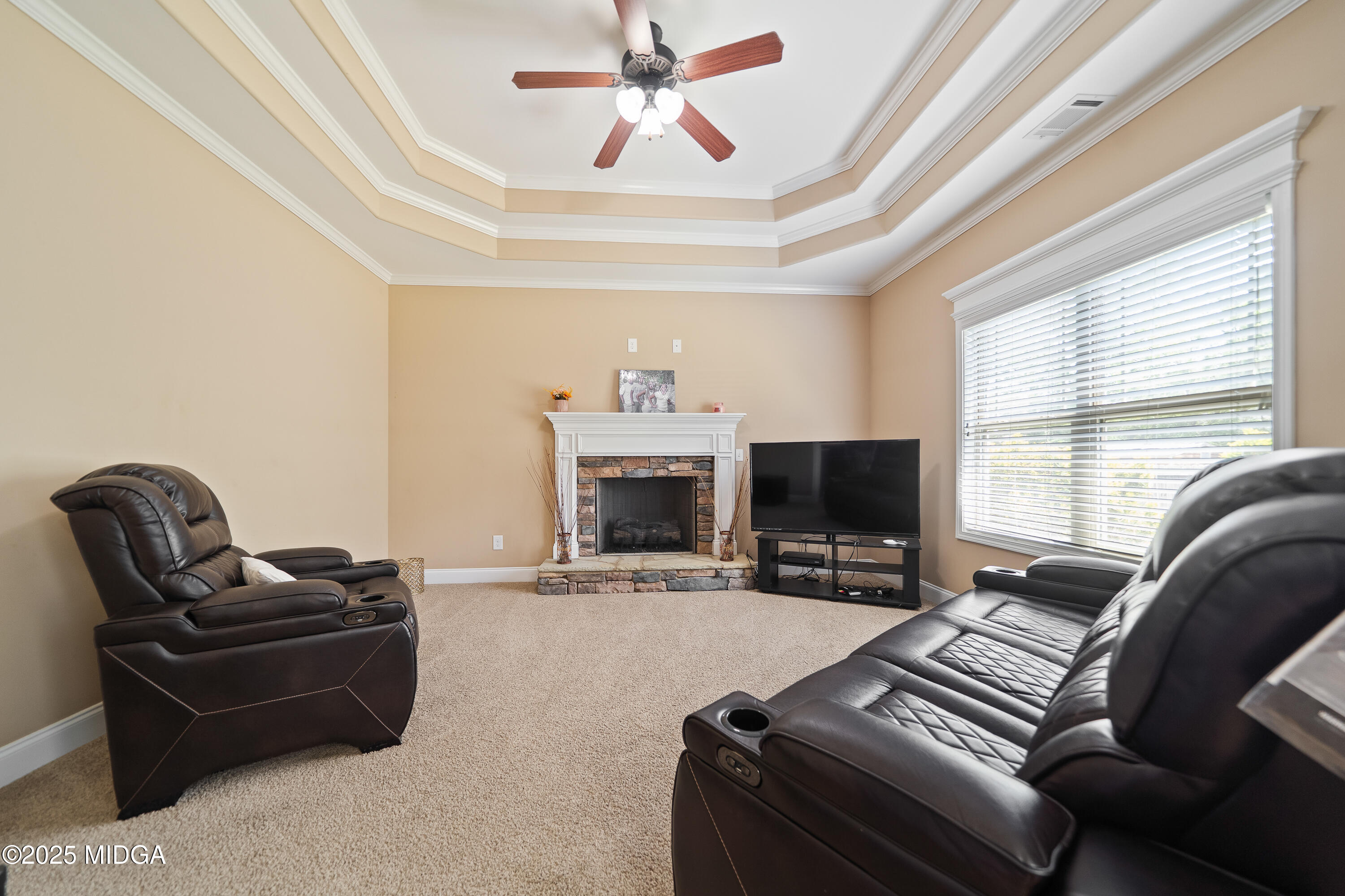 405 Stonecrest Court Macon, GA 31216 - Photo 20 of 45 a living room with furniture a fireplace and a large window