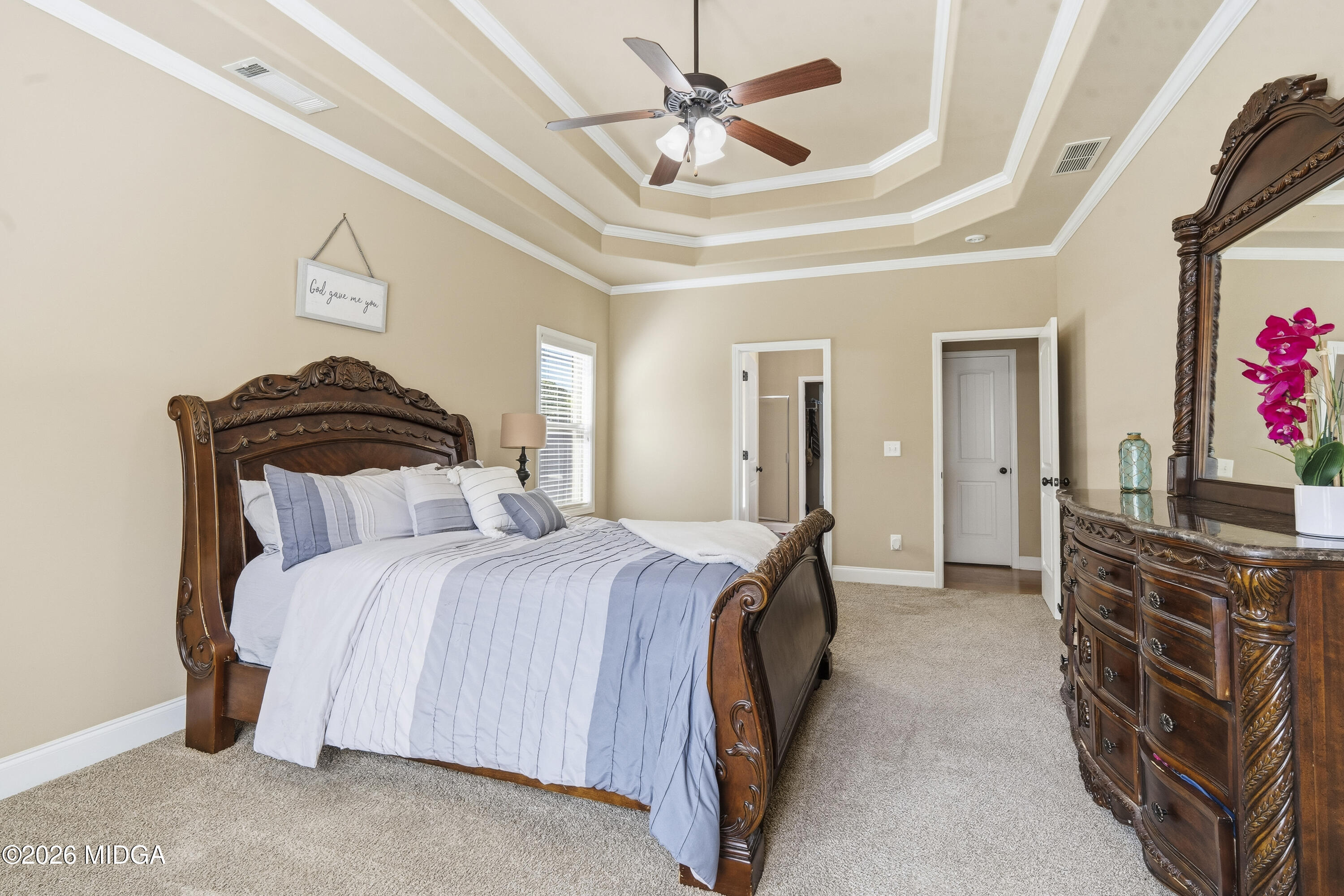 405 Stonecrest Court Macon, GA 31216 - Photo 24 of 45 a bedroom with a bed and a chandelier