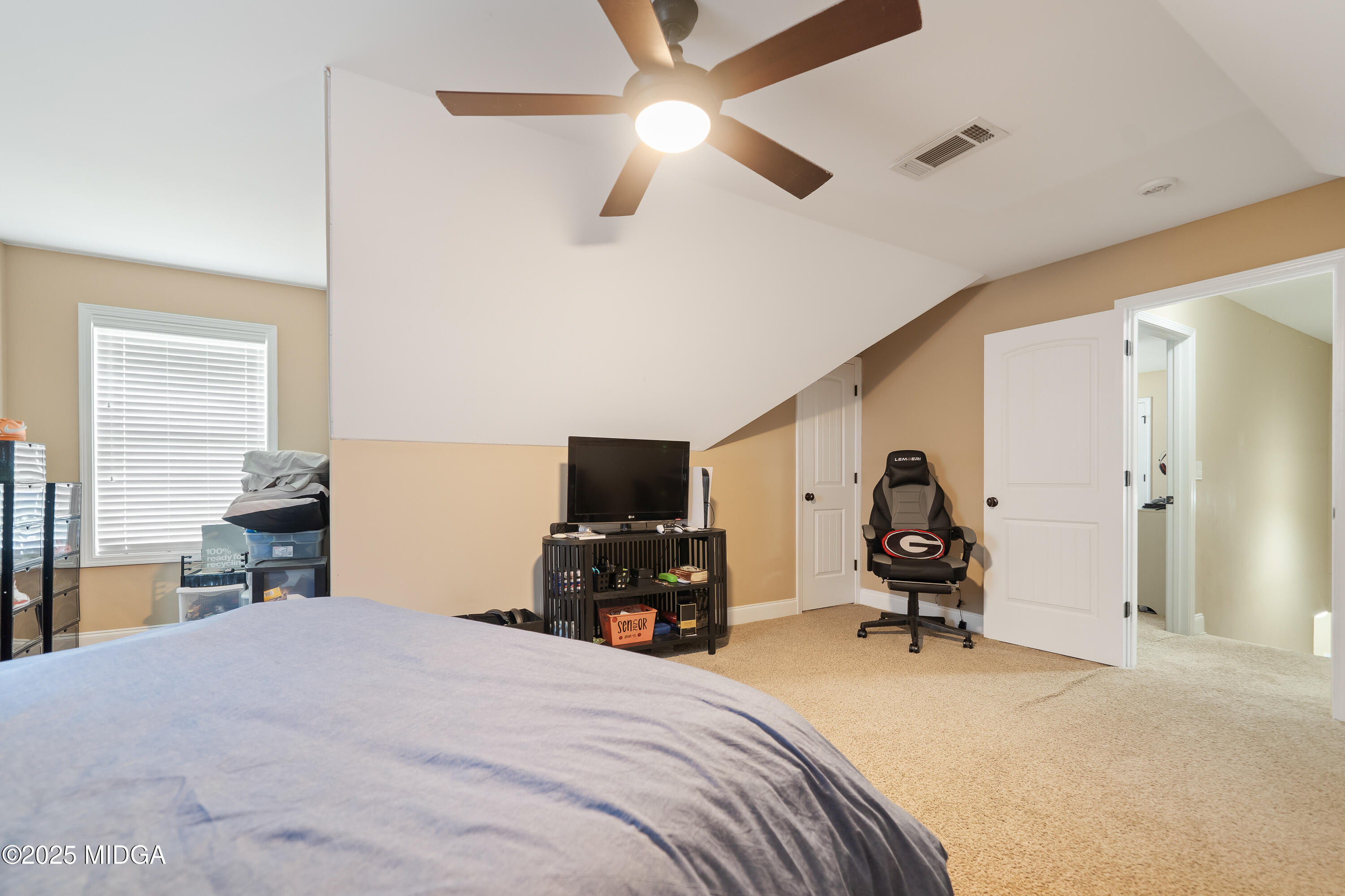 405 Stonecrest Court Macon, GA 31216 - Photo 35 of 45 a bedroom with a bed and a chandelier