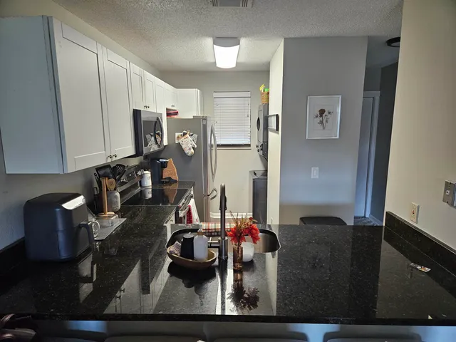 a view of a workspace with furniture and lamp