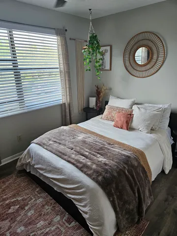 a bedroom with a bed and a window