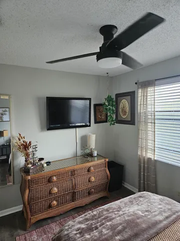 a bedroom with furniture and a flat screen tv