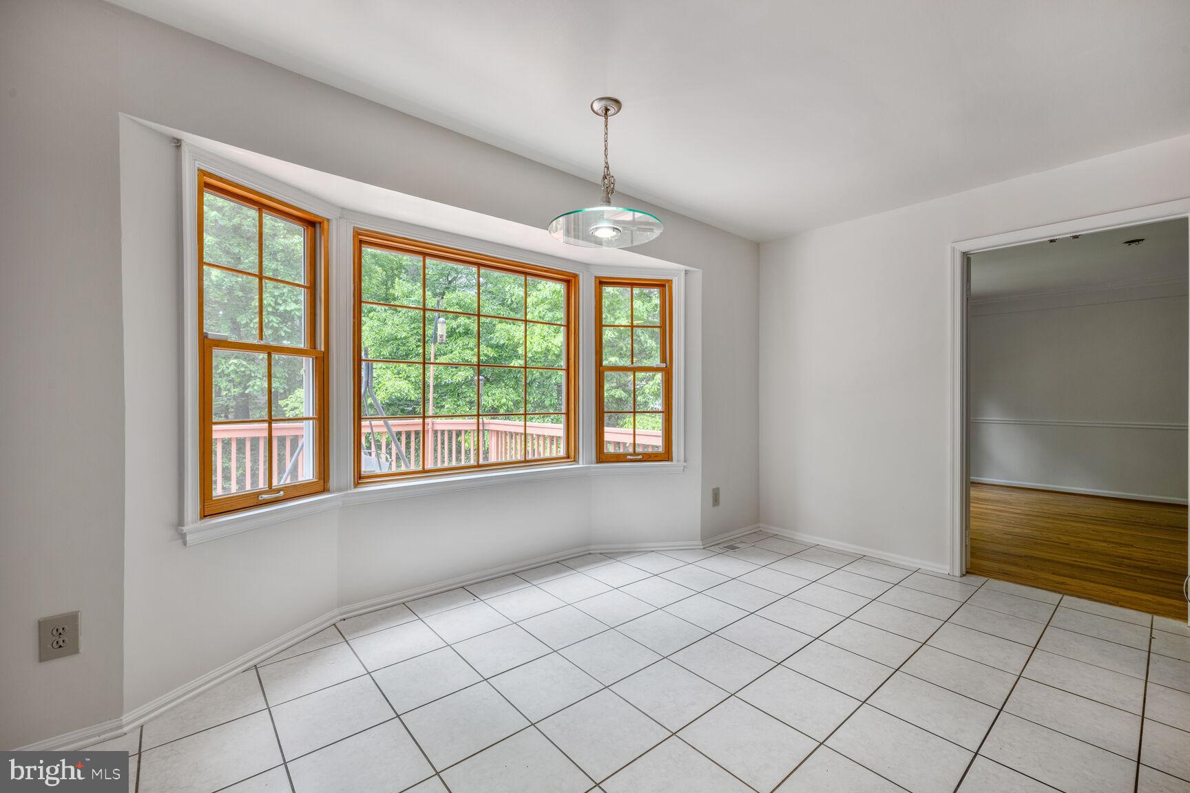 9605 Reach Road Potomac, MD 20854 - Photo 13 of 44 a view of an empty room with window chandelier and window