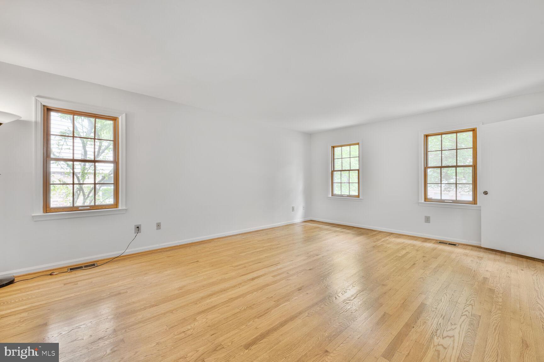 9605 Reach Road Potomac, MD 20854 - Photo 18 of 44 a view of an empty room with wooden floor and a window