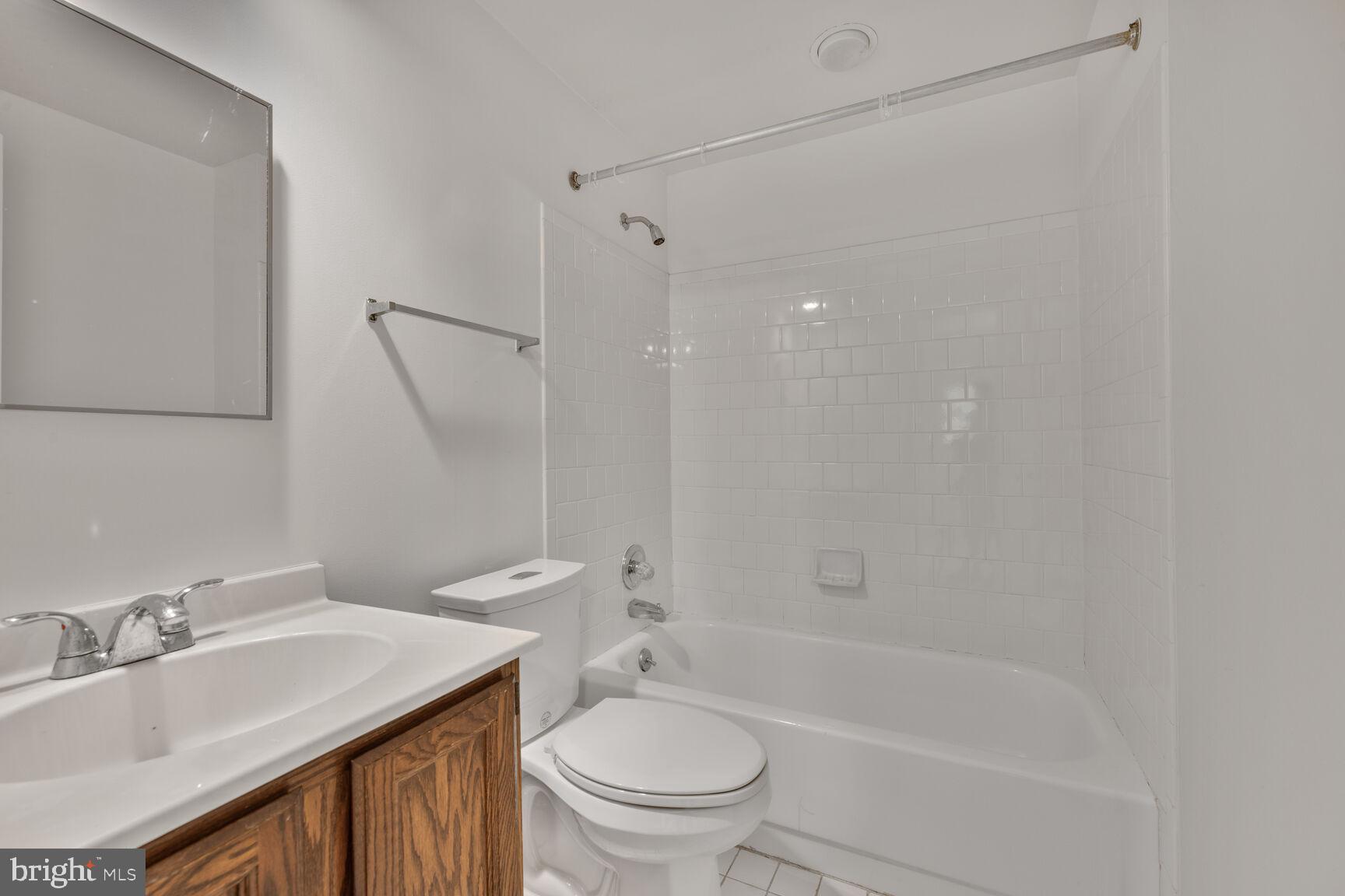9605 Reach Road Potomac, MD 20854 - Photo 33 of 44 a bathroom with a granite countertop sink toilet and shower