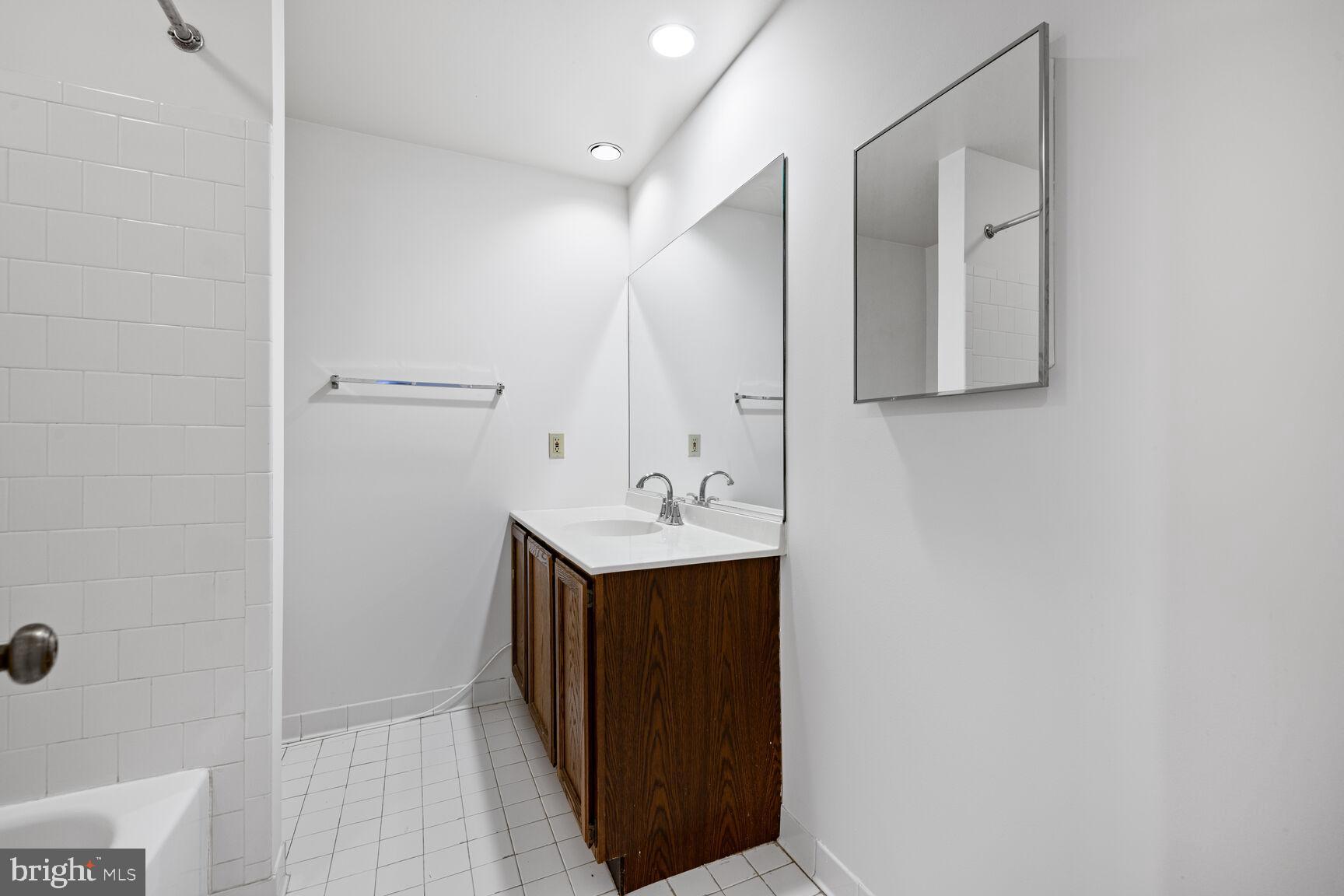 9605 Reach Road Potomac, MD 20854 - Photo 35 of 44 a bathroom with a sink and a mirror