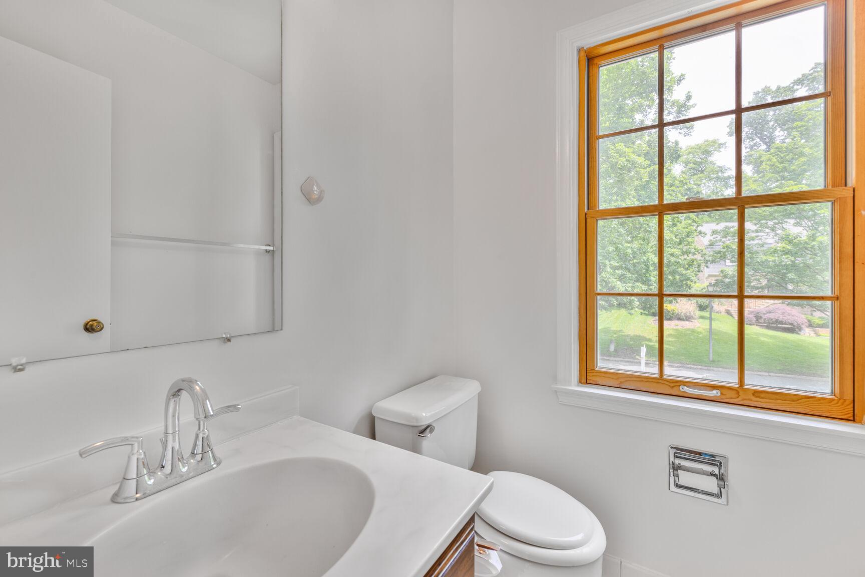 9605 Reach Road Potomac, MD 20854 - Photo 36 of 44 a bathroom with a sink vanity mirror and toilet
