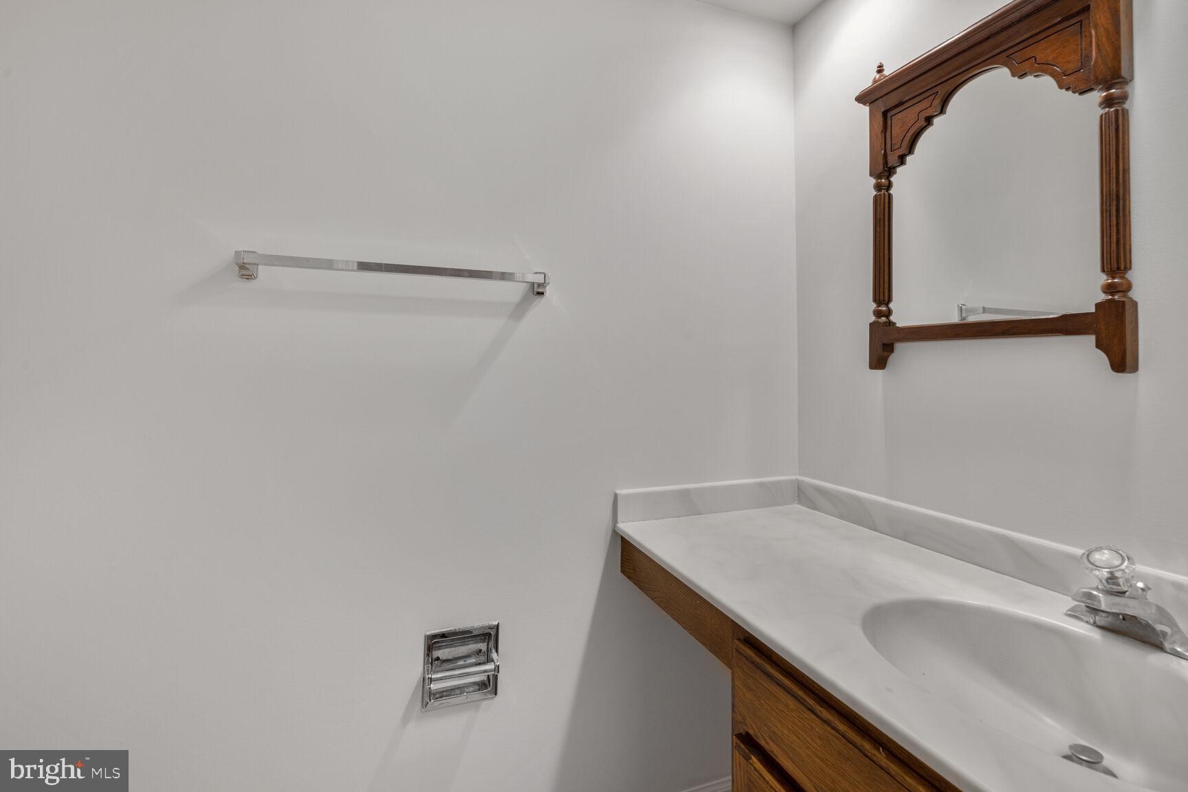 9605 Reach Road Potomac, MD 20854 - Photo 37 of 44 a bathroom with a sink and mirror