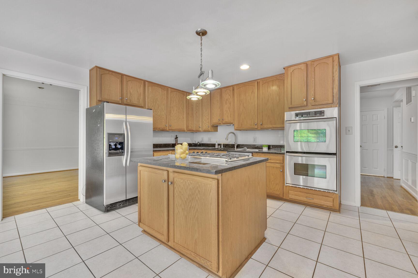 9605 Reach Road Potomac, MD 20854 - Photo 9 of 44 a kitchen with stainless steel appliances granite countertop a refrigerator and a stove top oven