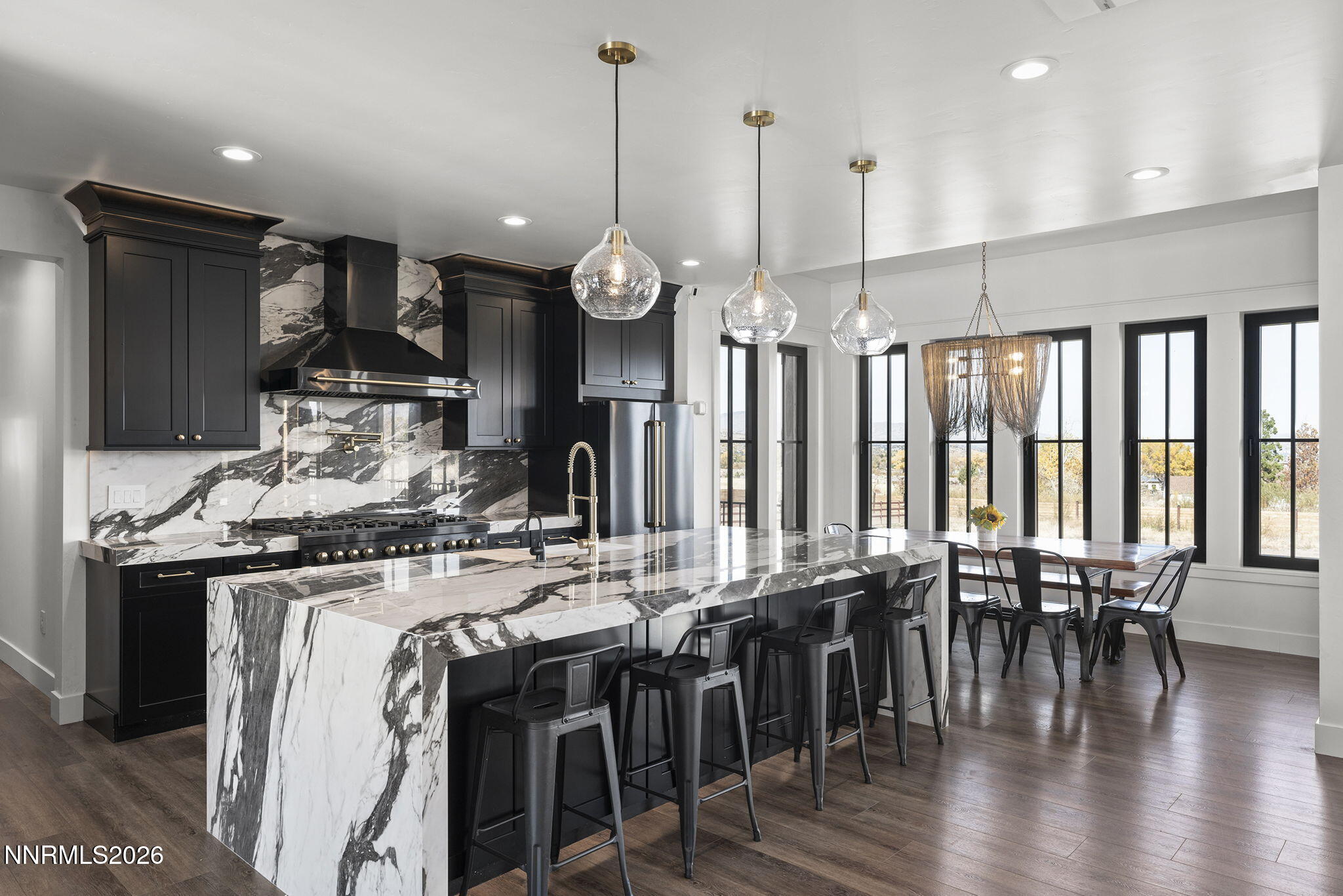 1426 Foothill Road Reno, NV 89511 - Photo 14 of 100 a kitchen with stainless steel appliances granite countertop a stove a refrigerator a kitchen island a dining table and chairs