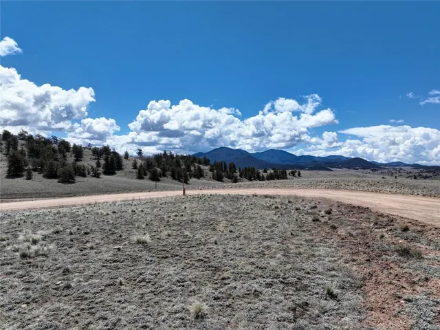 a view of a yard with wooden fence