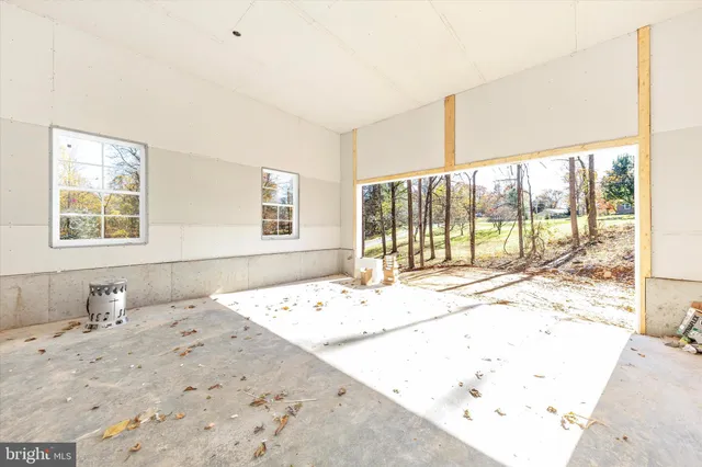a view of a bedroom with wooden floor and a window
