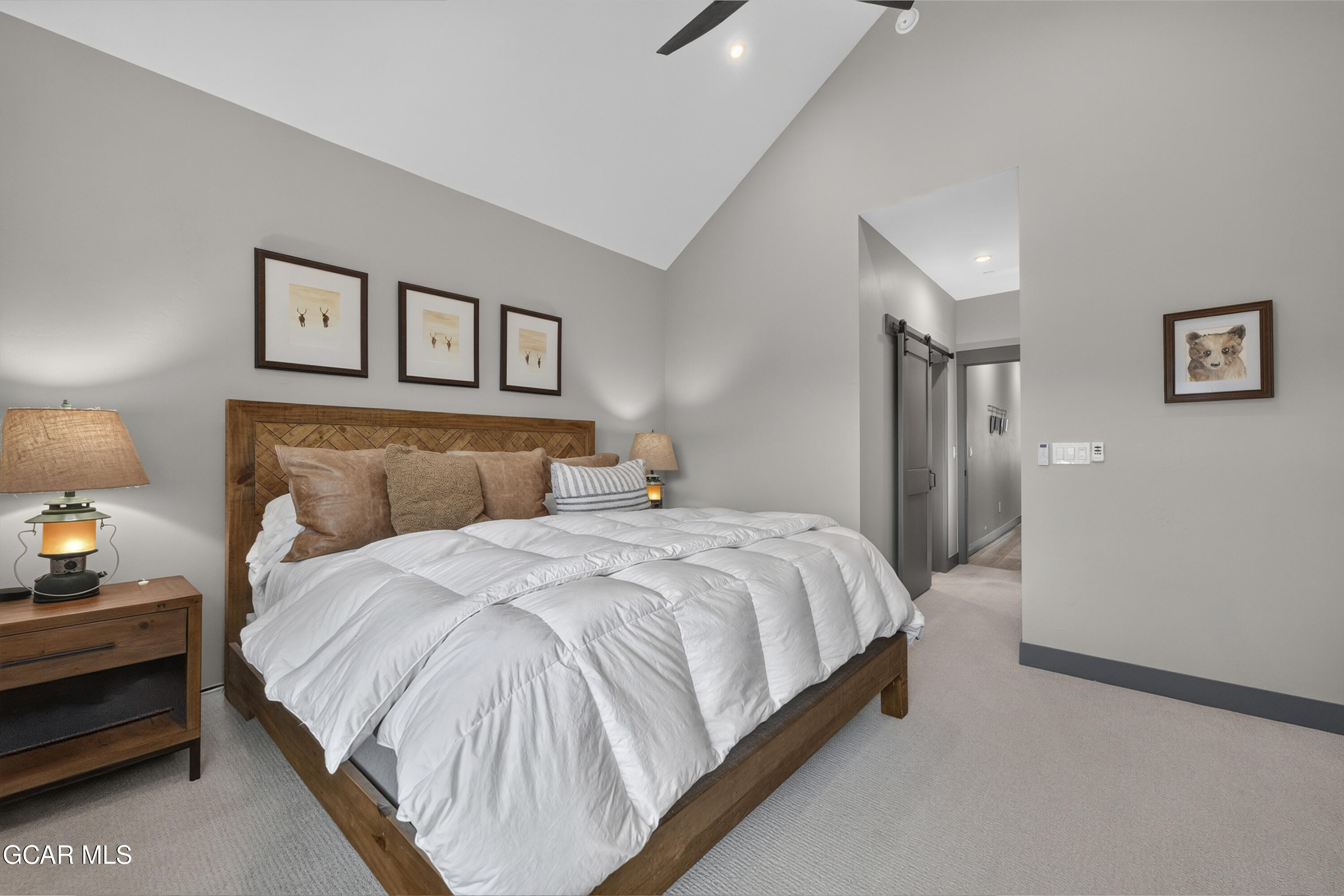 154 Eagle Ridge Drive Granby, CO 80446 - Photo 31 of 59 a bedroom with bed and paintings on the wall