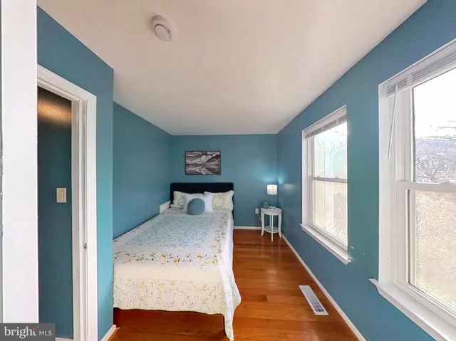 a bedroom with a bed and a large window with outer view