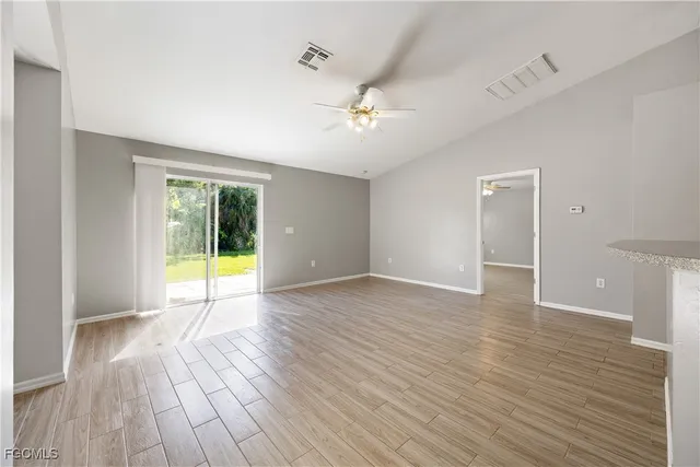 wooden floor in an empty room with a window