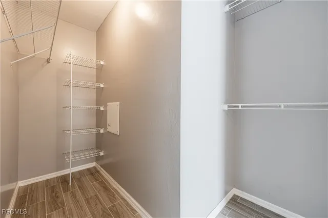 a view of a room with wooden floor