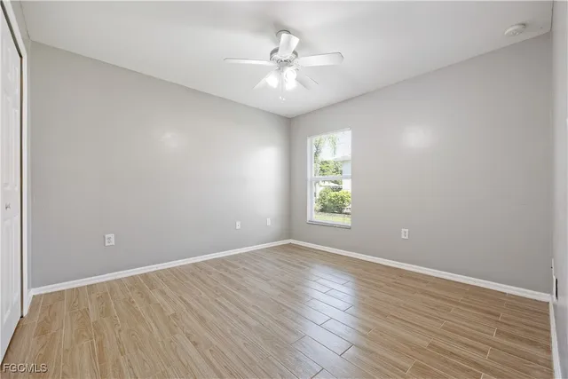 wooden floor in an empty room with a window