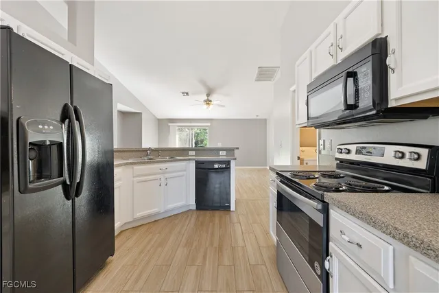 a kitchen with stainless steel appliances granite countertop a stove sink and refrigerator