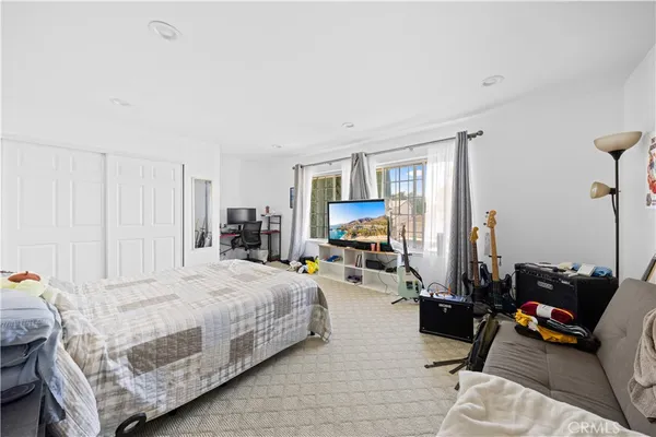a bedroom with a bed couch and a window