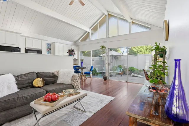a living room with furniture and flowers