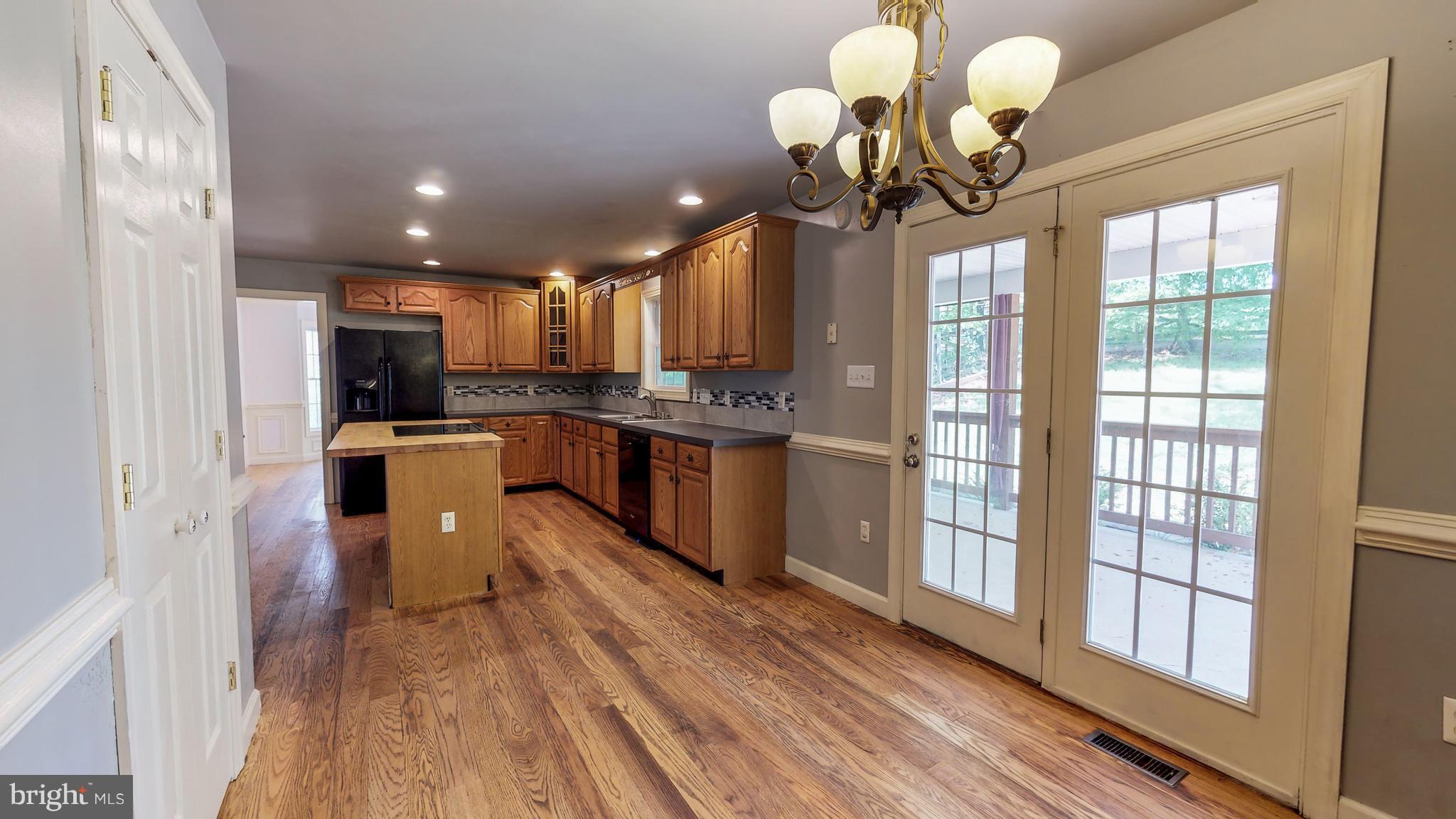 141 Holiday Road Cross Junction, VA 22625 - Photo 12 of 30 a view of a kitchen with granite countertop stainless steel appliances cabinets a sink and a chandelier