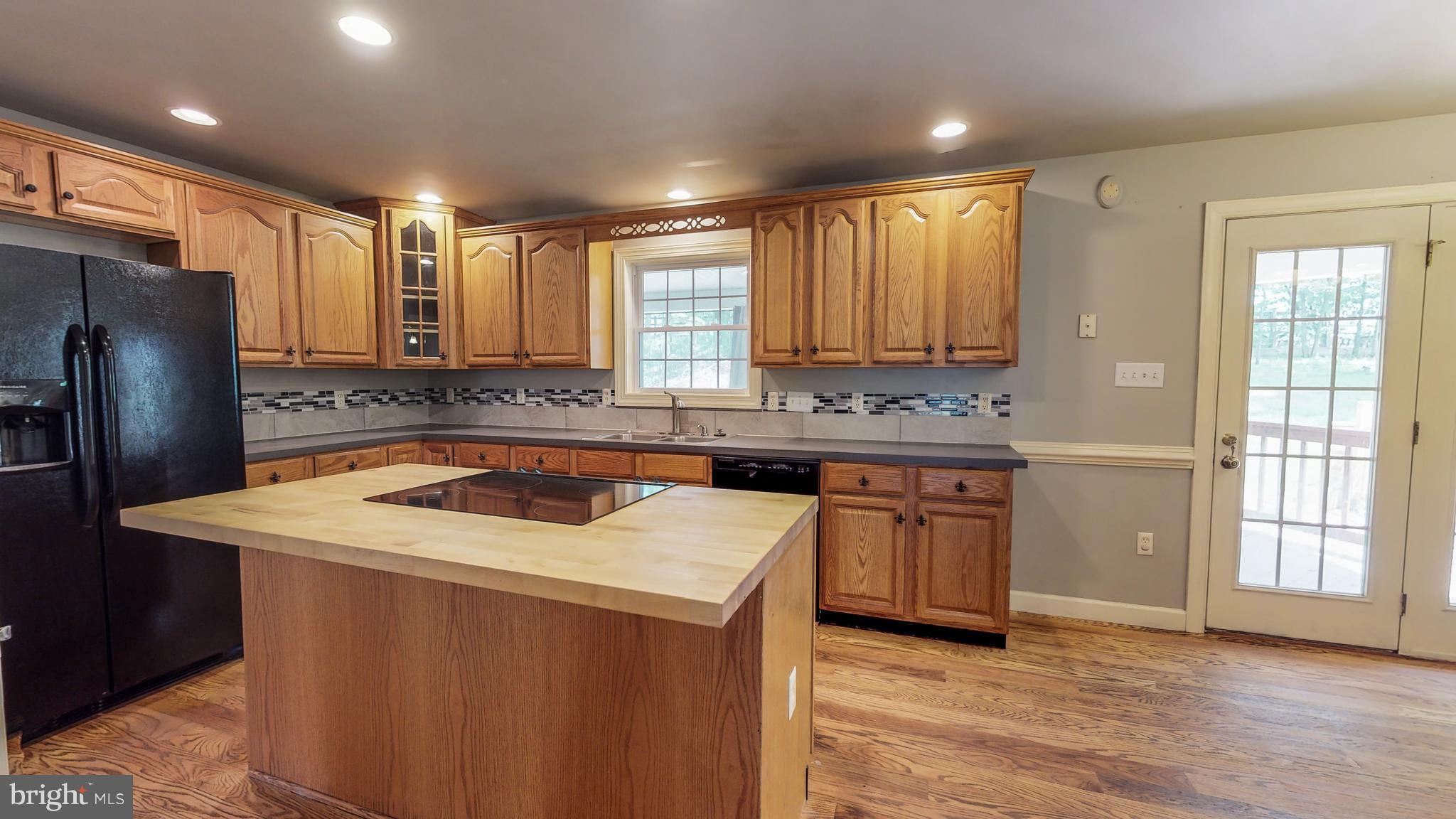 141 Holiday Road Cross Junction, VA 22625 - Photo 13 of 30 a kitchen with stainless steel appliances granite countertop a sink stove and refrigerator