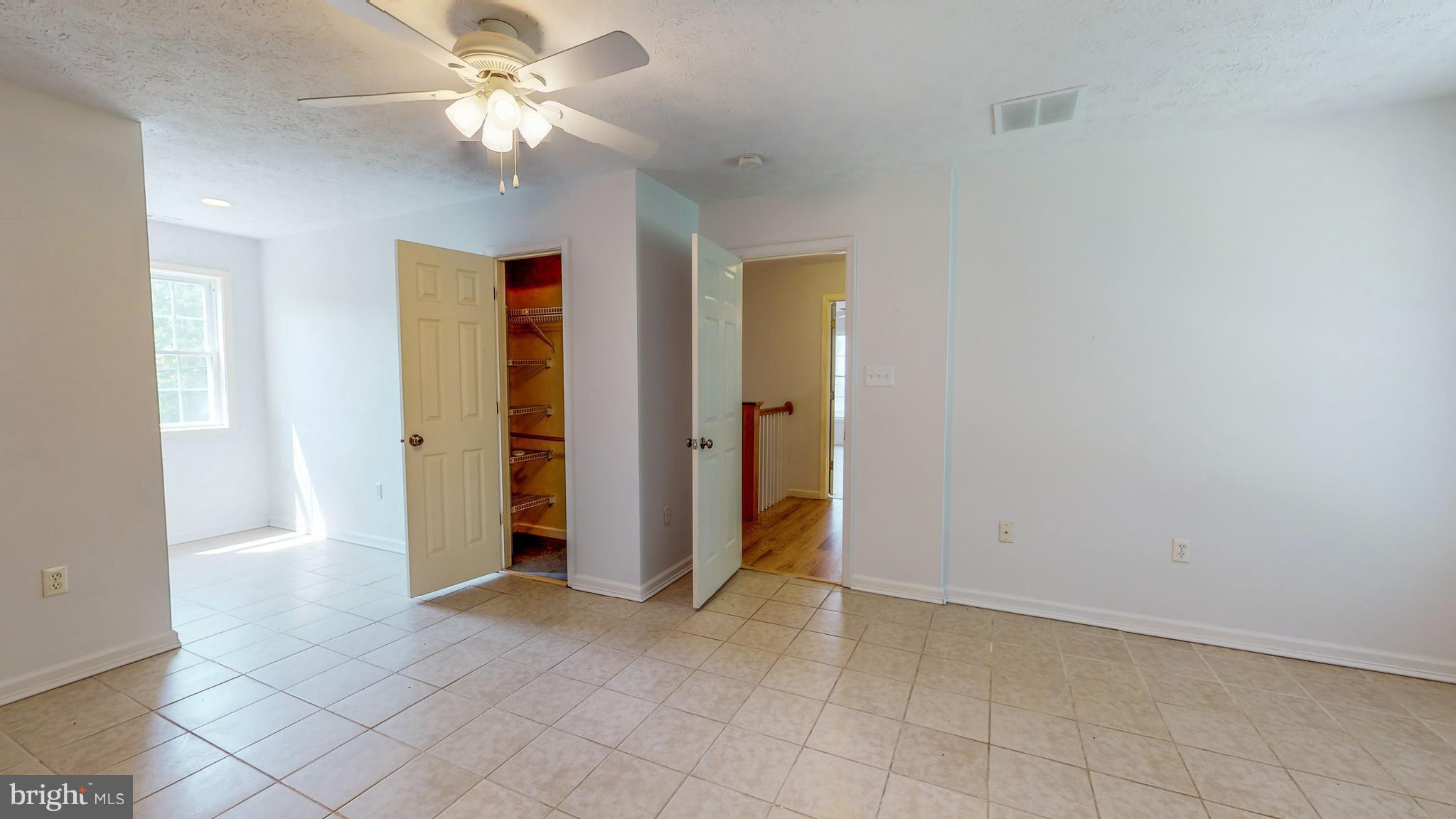 141 Holiday Road Cross Junction, VA 22625 - Photo 20 of 30 an empty room with closet and a ceiling fan