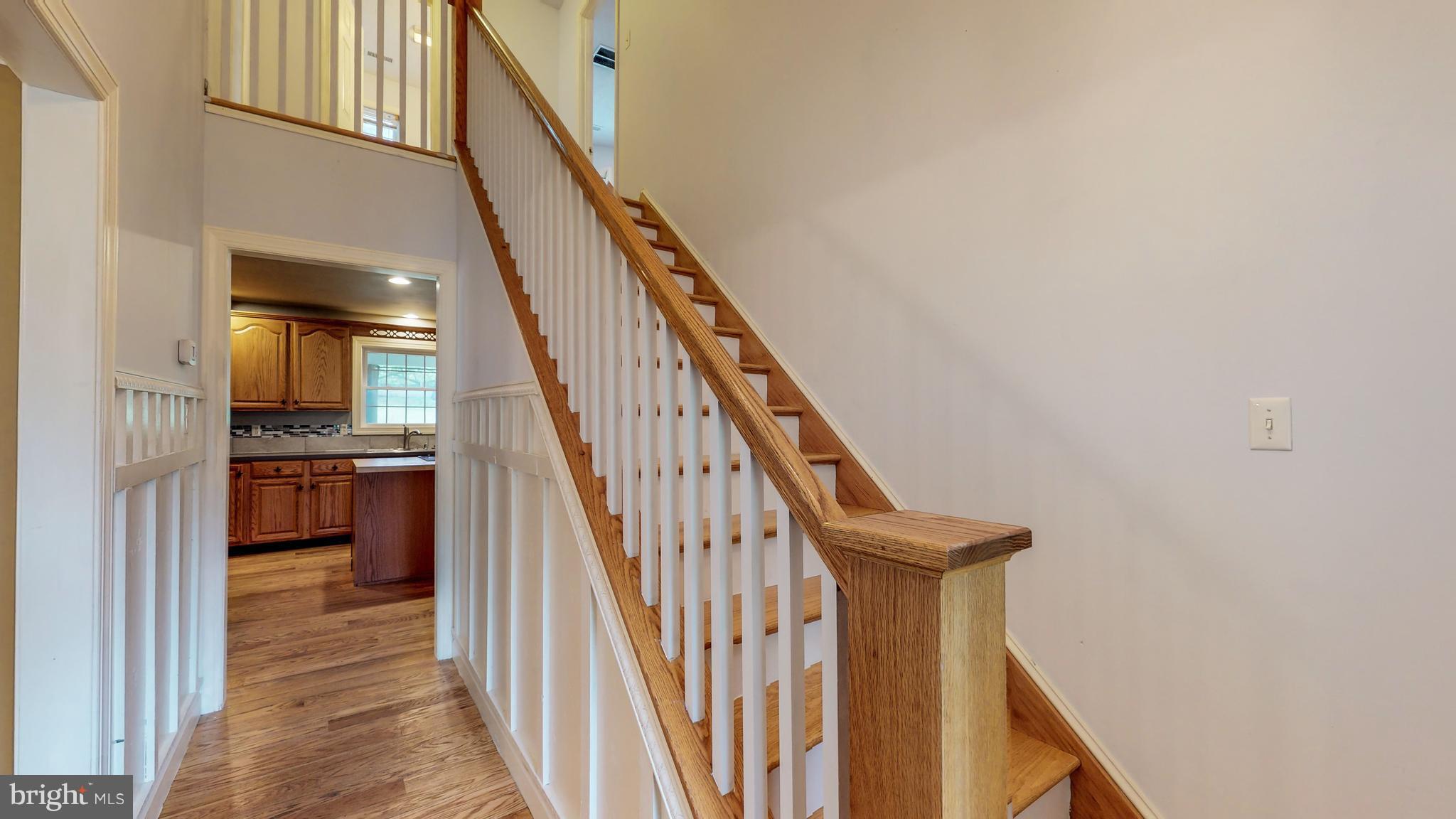 141 Holiday Road Cross Junction, VA 22625 - Photo 4 of 30 a view of staircase with lots of frames on wall and windows