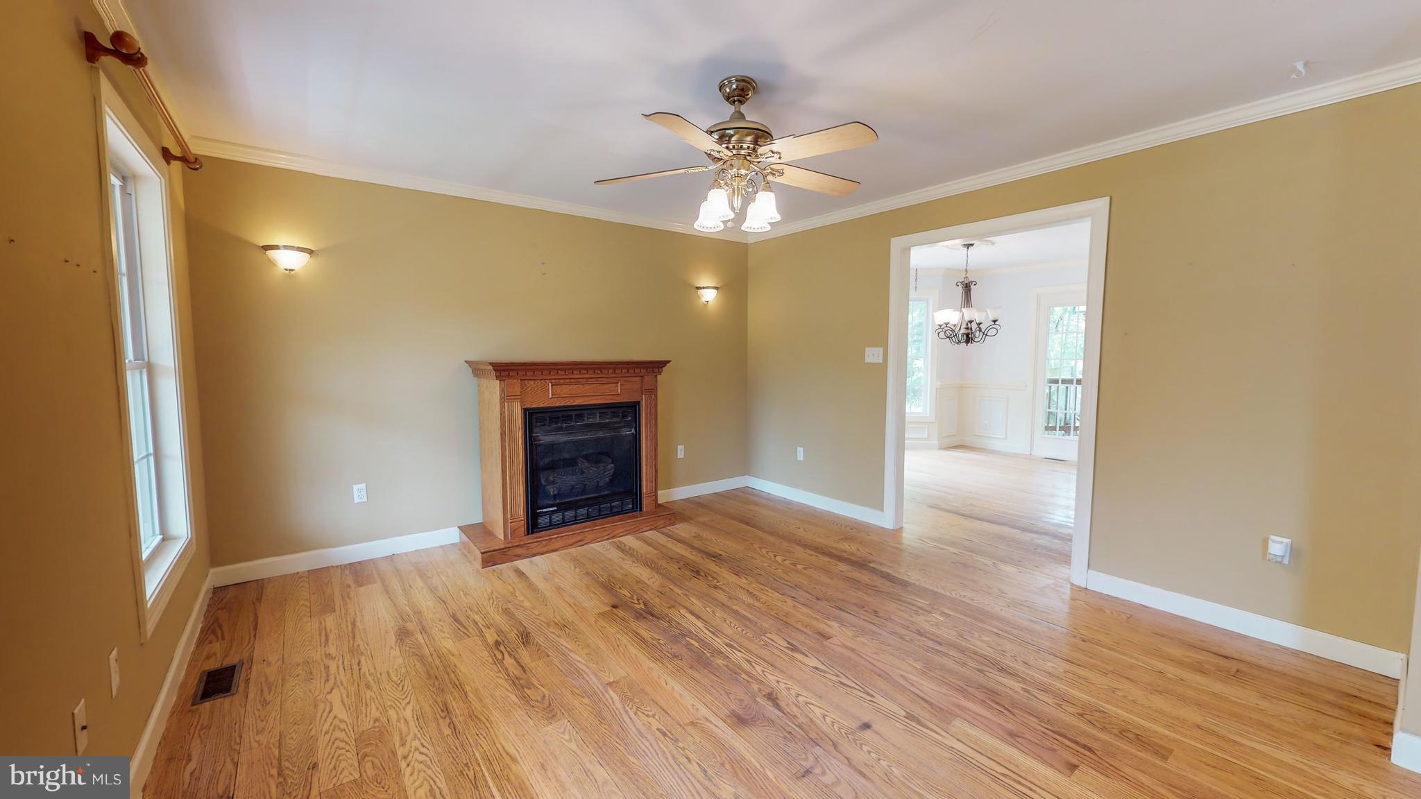 141 Holiday Road Cross Junction, VA 22625 - Photo 6 of 30 a view of an empty room with a fireplace and a window