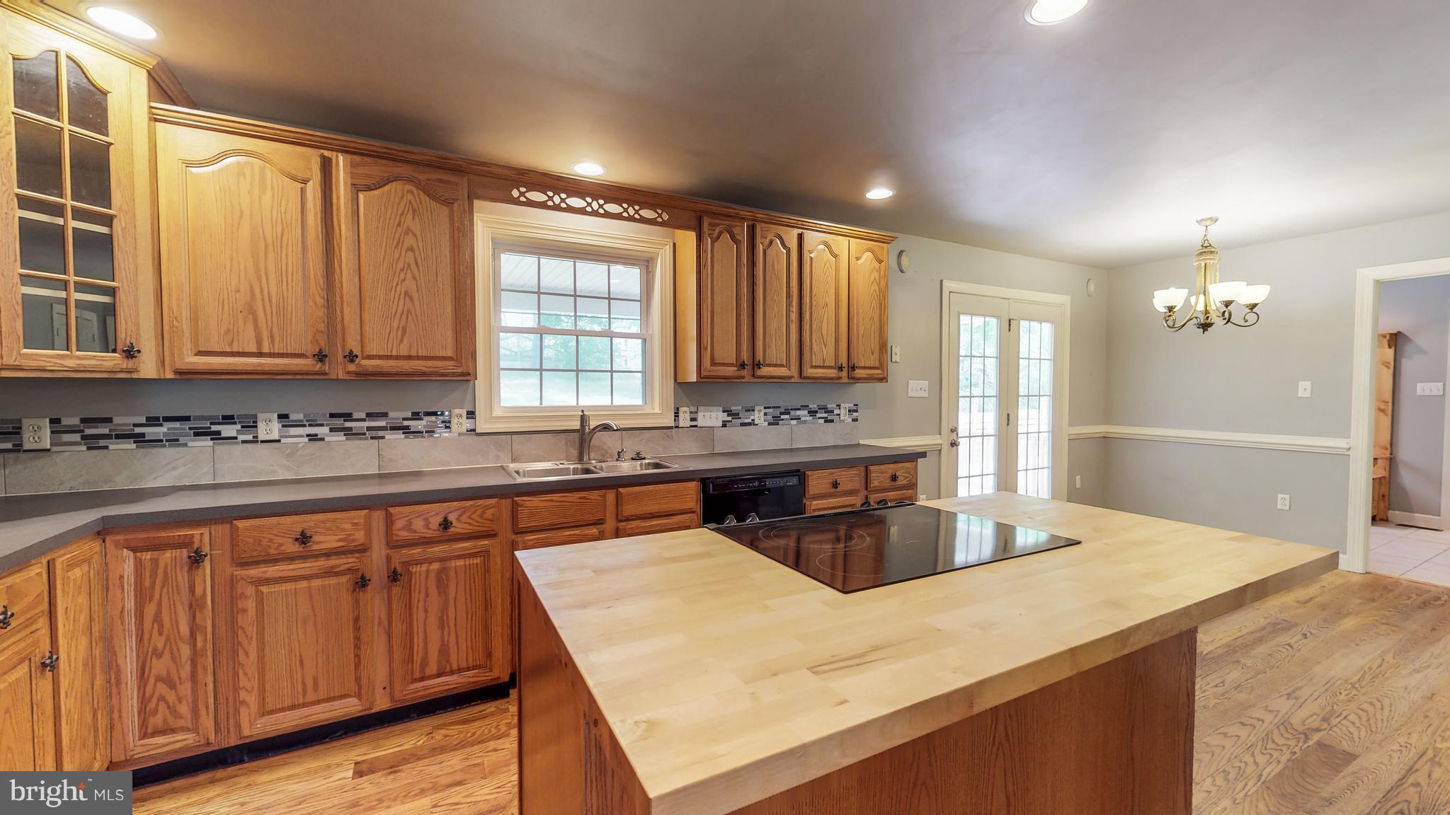141 Holiday Road Cross Junction, VA 22625 - Photo 10 of 30 a kitchen with stainless steel appliances granite countertop wooden cabinets a stove and a sink