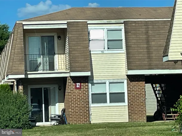 a view of a house with more windows and a yard