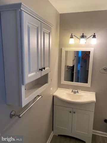 a bathroom with a double vanity sink mirror and bathtub