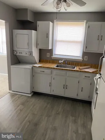a kitchen with cabinets a sink and a stove top oven