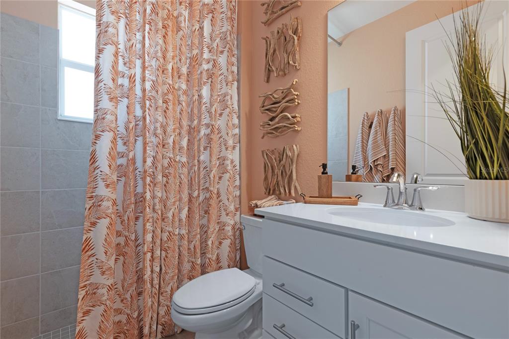 7157 Inlet Isles Lakewood Ranch, FL 34202 - Photo 25 of 26 a bathroom with a sink a toilet and a mirror