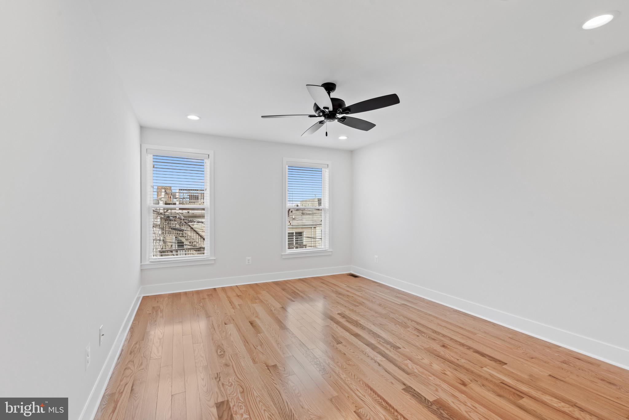 1434 Marshall Street Baltimore, MD 21230 - Photo 18 of 40 a view of empty room with wooden floor and fan