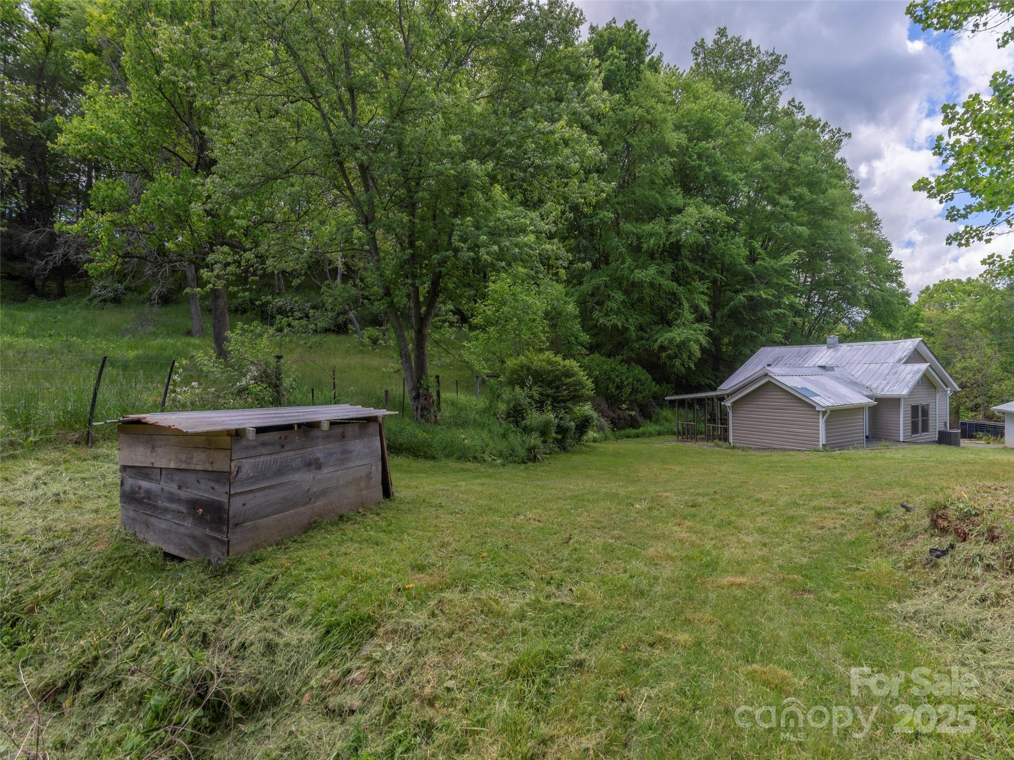 280 Noland Drive Clyde, NC 28721 - Photo 11 of 32 a view of a house with a yard and green space
