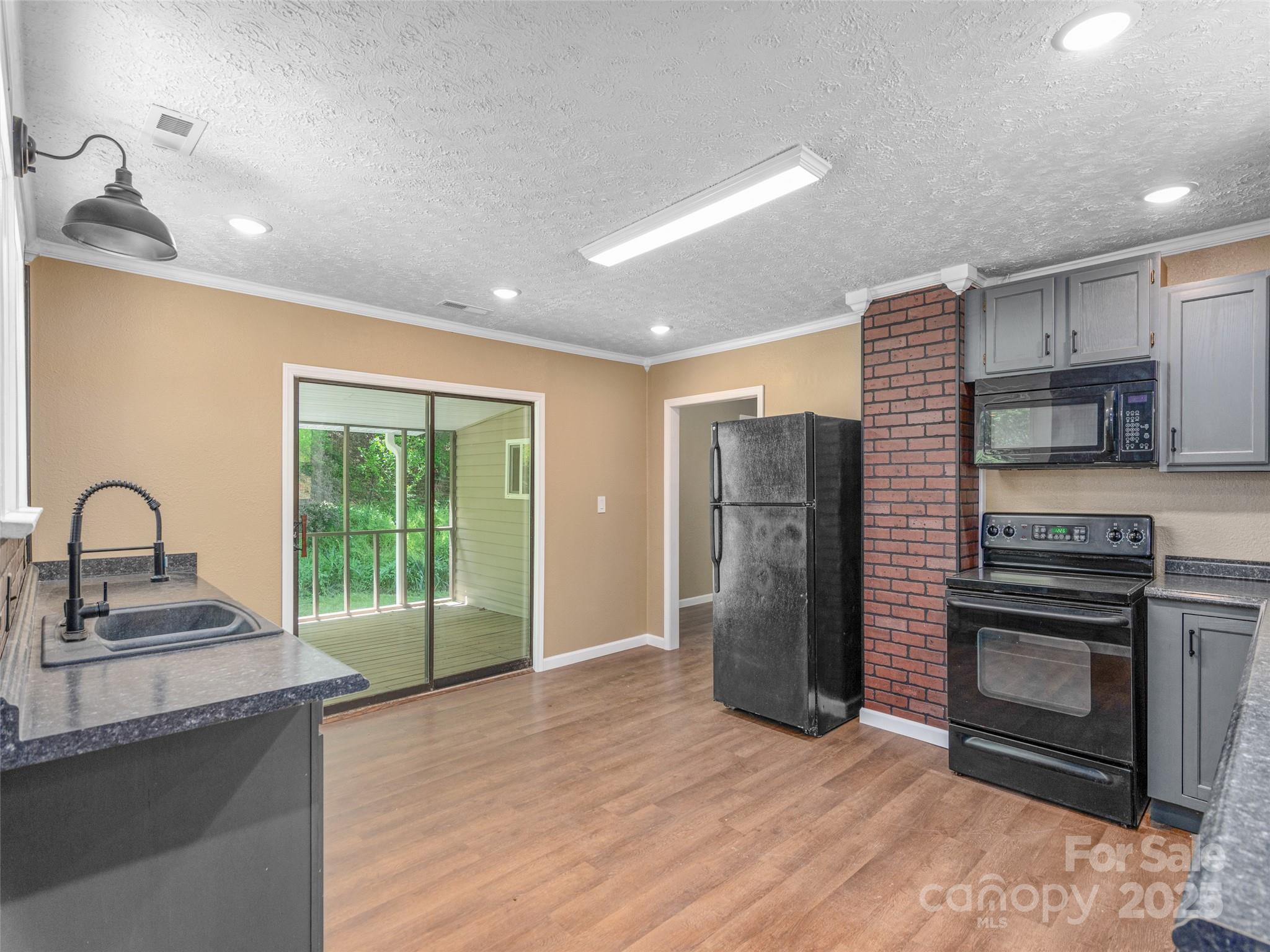 280 Noland Drive Clyde, NC 28721 - Photo 19 of 32 a kitchen with stainless steel appliances granite countertop a refrigerator sink and stove