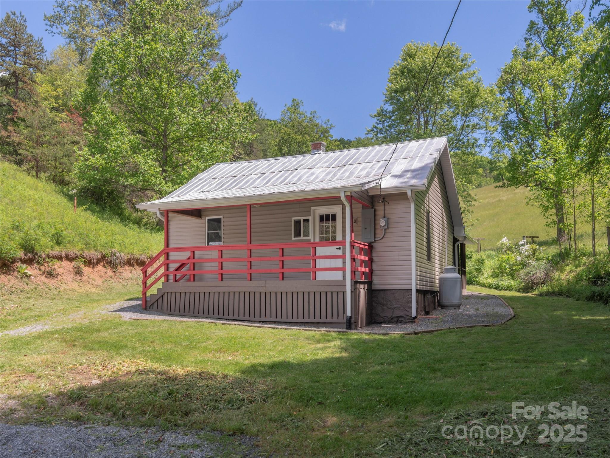 280 Noland Drive Clyde, NC 28721 - Photo 28 of 32 a view of a house with a backyard