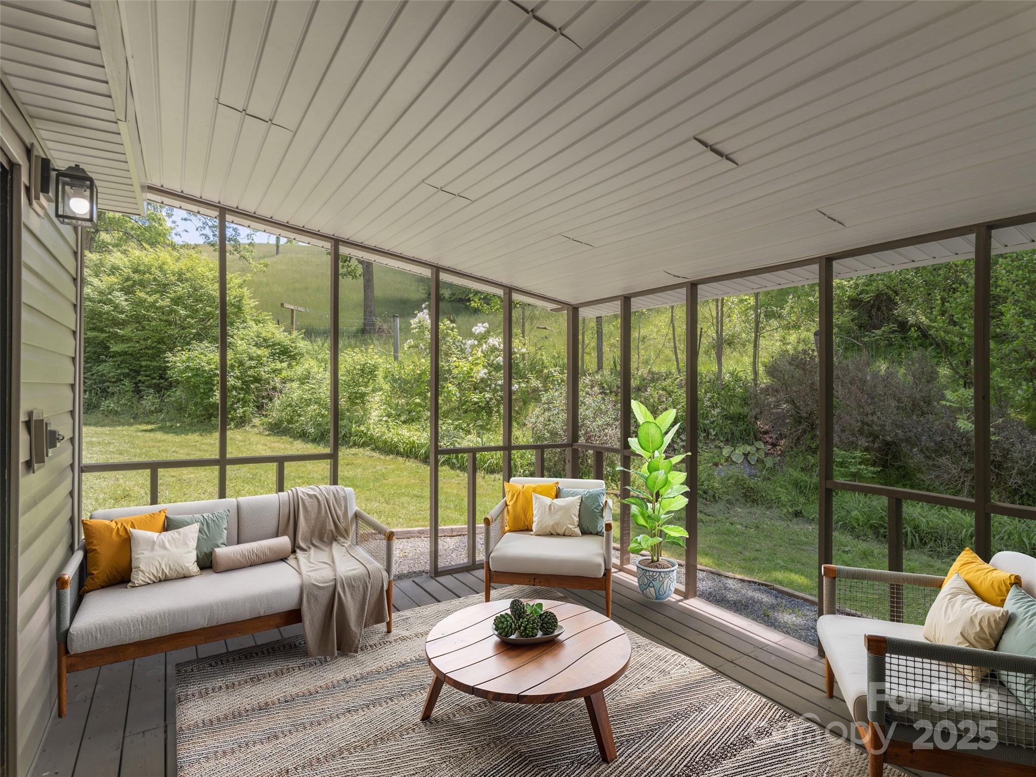 280 Noland Drive Clyde, NC 28721 - Photo 5 of 32 a living room with furniture and a floor to ceiling window