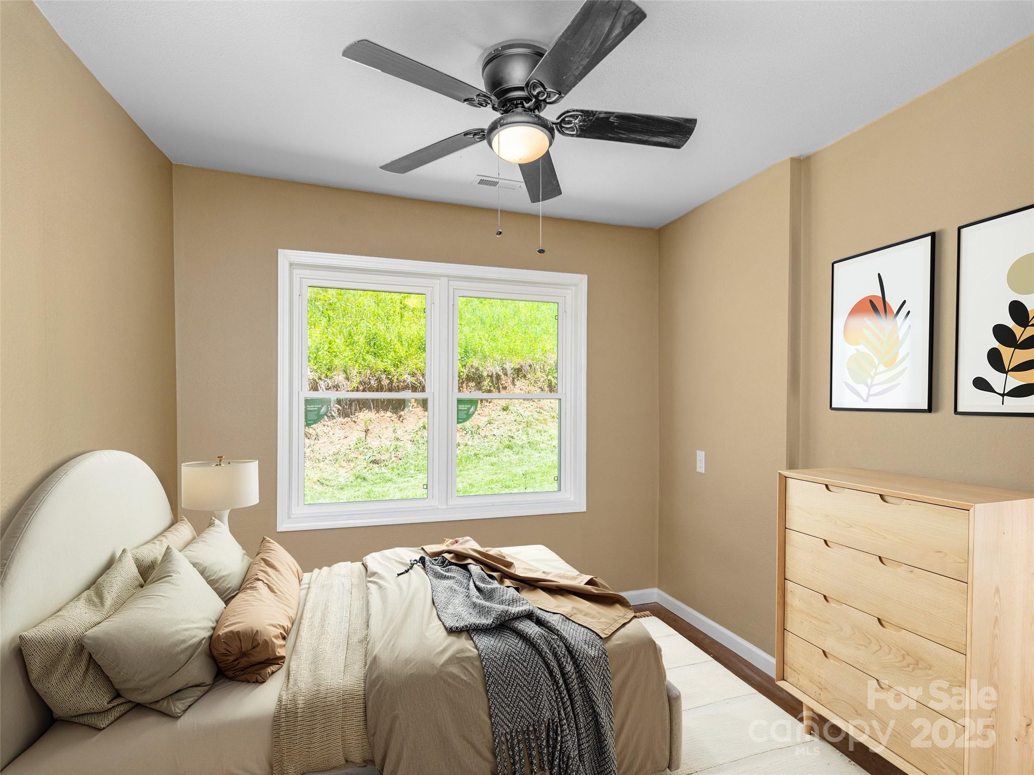 280 Noland Drive Clyde, NC 28721 - Photo 7 of 32 a bed sitting in a bedroom next to a window