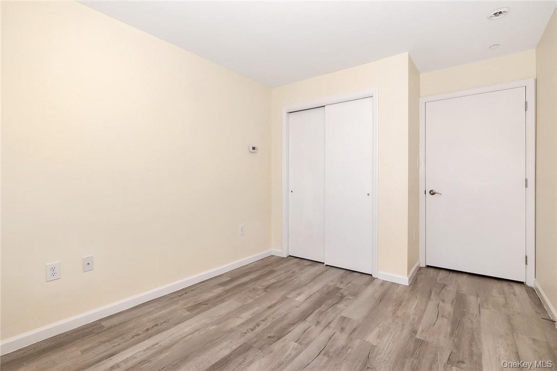 68 Lake Street, Unit 108 White Plains, NY 10601 - Photo 12 of 36 a view of an empty room with wooden floor