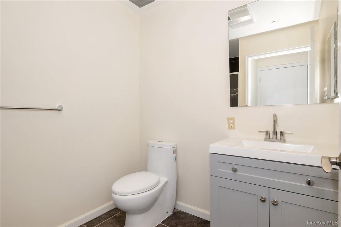 68 Lake Street, Unit 108 White Plains, NY 10601 - Photo 24 of 36 a bathroom with a toilet sink and mirror