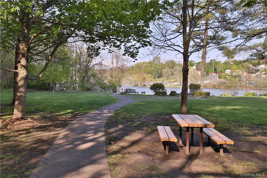 68 Lake Street, Unit 108 White Plains, NY 10601 - Photo 36 of 36 a view of a backyard with table and chairs a fire pit and a large tree