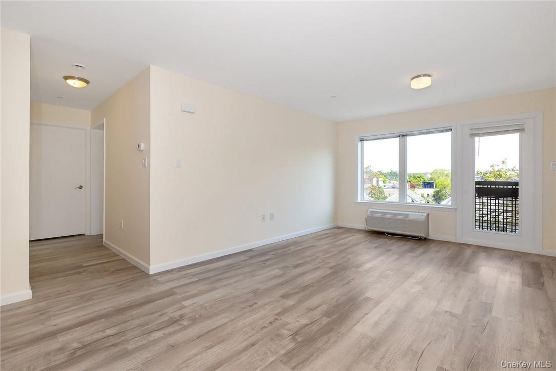 68 Lake Street, Unit 108 White Plains, NY 10601 - Photo 4 of 36 an empty room with wooden floor and windows