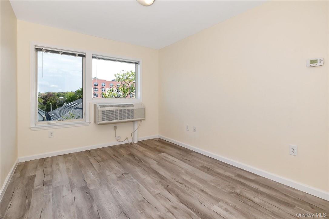 68 Lake Street, Unit 108 White Plains, NY 10601 - Photo 5 of 36 an empty room with wooden floor and a window
