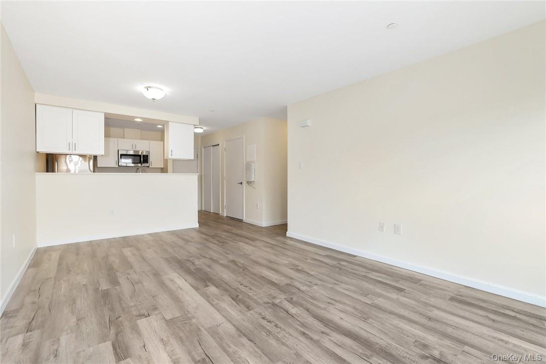 68 Lake Street, Unit 108 White Plains, NY 10601 - Photo 10 of 36 a view of a kitchen with a sink and a refrigerator