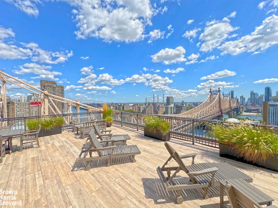 35 Sutton Place, Unit 14F Manhattan, NY 10022 - Photo 12 of 15 a view of a swimming pool with seating space