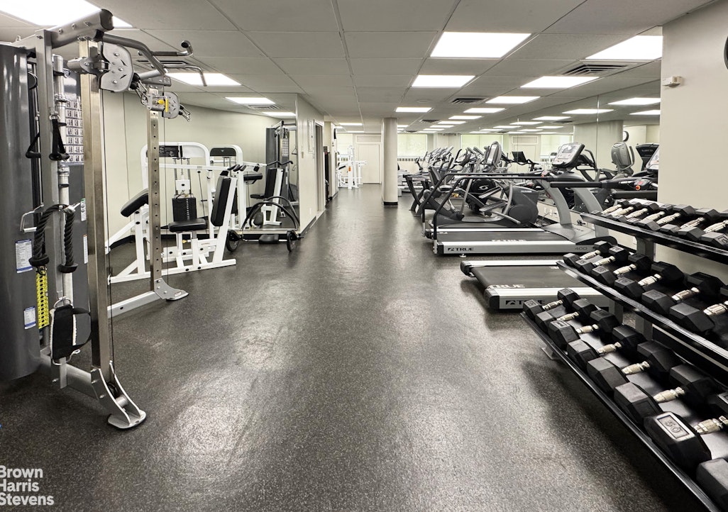 35 Sutton Place, Unit 14F Manhattan, NY 10022 - Photo 14 of 15 a view of a room with gym equipment